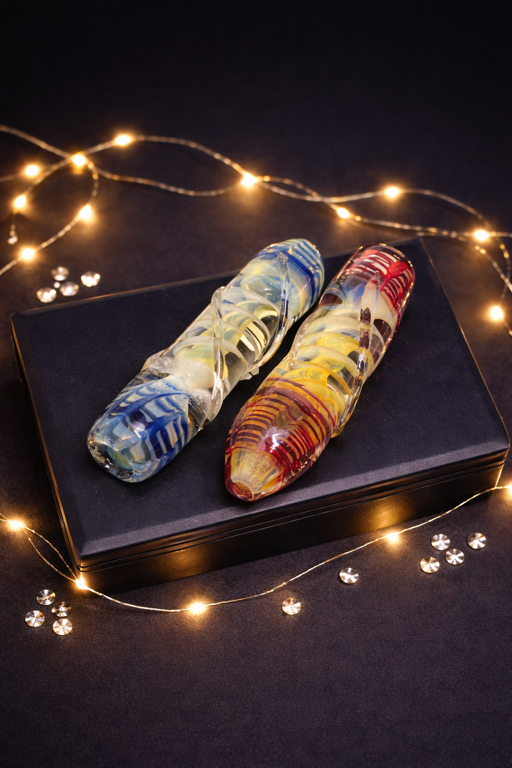 Colorful glass pipes on black background